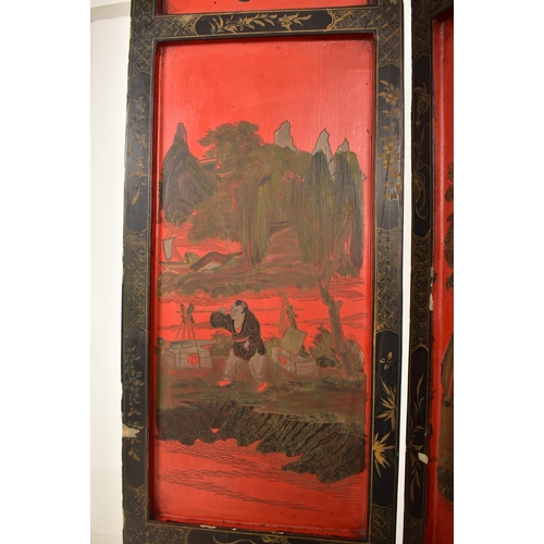 603 - An early 20th century Chinese four-fold black and red lacquered room divider / dressing screen. The ... 