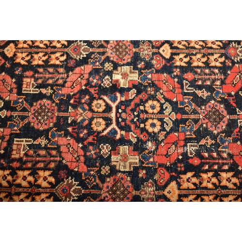 604 - An early 20th century Persian Islamic Maleyer floor carpet runner rug. The rug having a central blac... 