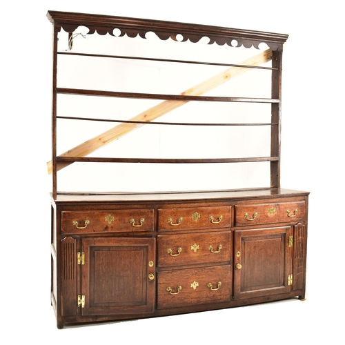 414 - A George III 18th century oak dresser. The dresser having an upright gallery plate rack  with flared... 