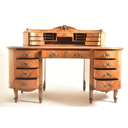 416 - A continental early 20th century walnut crossbanded twin pedestal kidney shaped desk. The desk havin... 