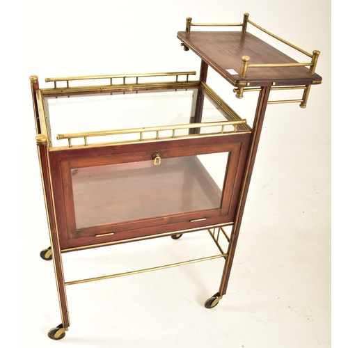 417 - An early 20th century circa 1900 mahogany & brass bound glazed cocktail drinks trolley. The trolley ... 