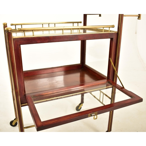 417 - An early 20th century circa 1900 mahogany & brass bound glazed cocktail drinks trolley. The trolley ... 