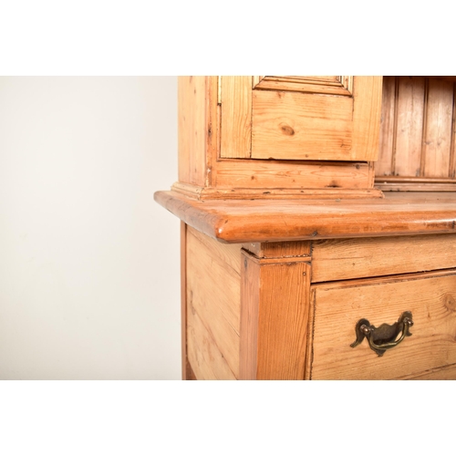 420 - A 19th century pine country Welsh dresser. The upright top having a carved gallery front over three ... 