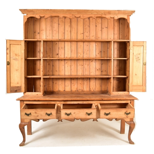 420 - A 19th century pine country Welsh dresser. The upright top having a carved gallery front over three ... 