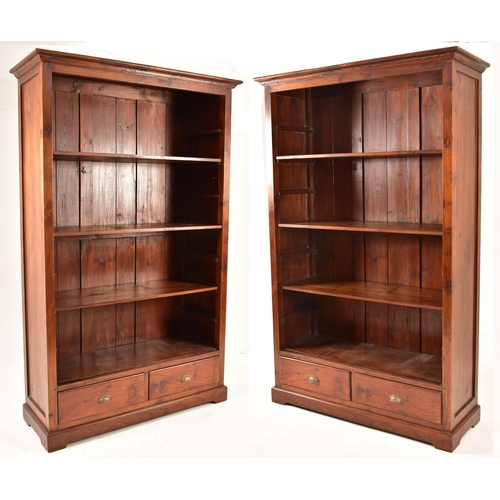 433 - A pair of Victorian style 20th century mahogany open front bookcases. Each bookcase having a cornice... 