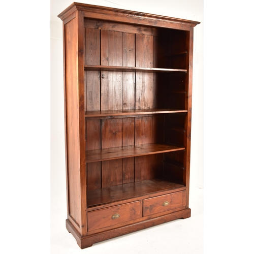 433 - A pair of Victorian style 20th century mahogany open front bookcases. Each bookcase having a cornice... 