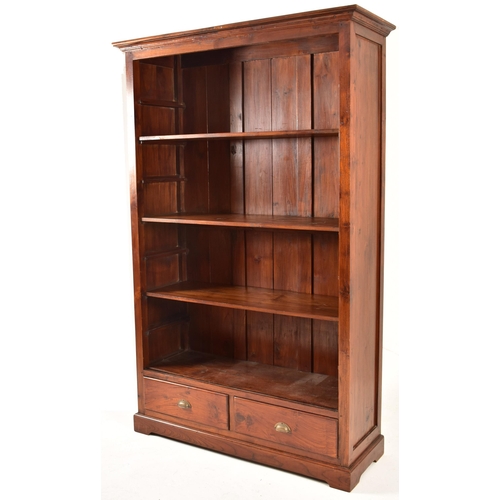 433 - A pair of Victorian style 20th century mahogany open front bookcases. Each bookcase having a cornice... 