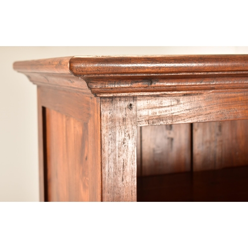 433 - A pair of Victorian style 20th century mahogany open front bookcases. Each bookcase having a cornice... 