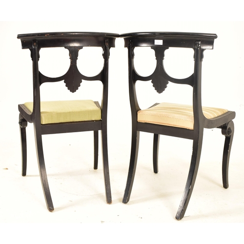 442 - A pair of Regency early 19th century ebonised wood dining chairs. Each chair having a curved top rai... 