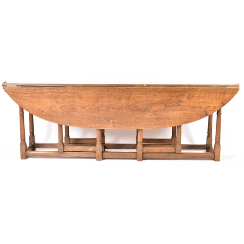 448 - An Irish manner large peg jointed solid oak wake dining table. The large table raised on block and t... 