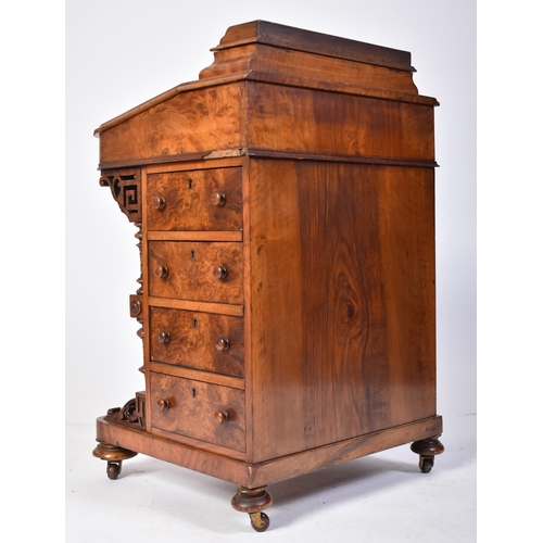 457 - A 19th century Victorian walnut Davenport desk. The desk with carved columns to the front having a b... 