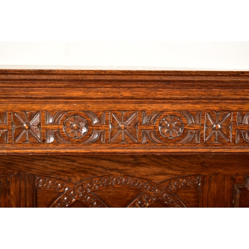 474 - A 1920's Jacobean Revival carved oak buffet cupboard cabinet. The buffet having a pediment top with ... 