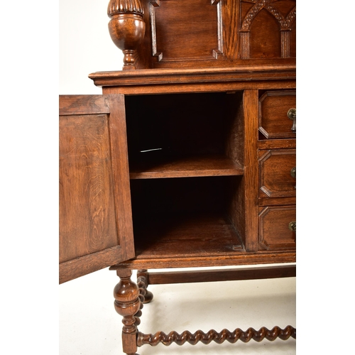 474 - A 1920's Jacobean Revival carved oak buffet cupboard cabinet. The buffet having a pediment top with ... 