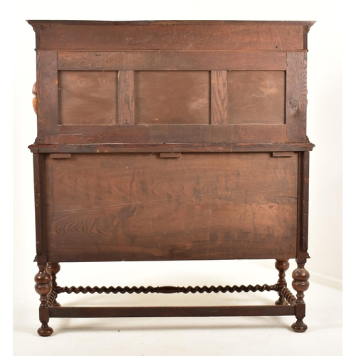 474 - A 1920's Jacobean Revival carved oak buffet cupboard cabinet. The buffet having a pediment top with ... 