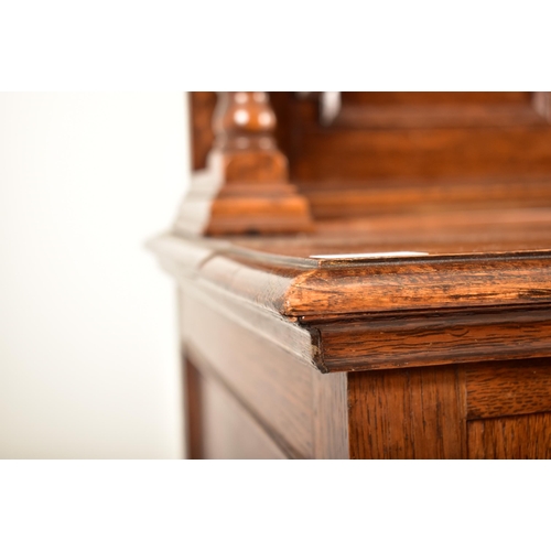 474 - A 1920's Jacobean Revival carved oak buffet cupboard cabinet. The buffet having a pediment top with ... 