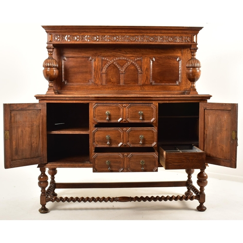 474 - A 1920's Jacobean Revival carved oak buffet cupboard cabinet. The buffet having a pediment top with ... 