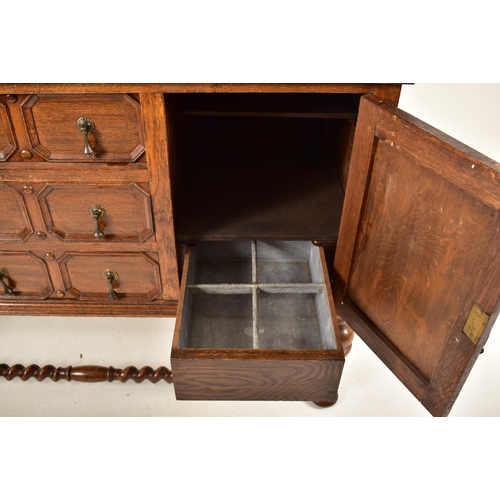 474 - A 1920's Jacobean Revival carved oak buffet cupboard cabinet. The buffet having a pediment top with ... 