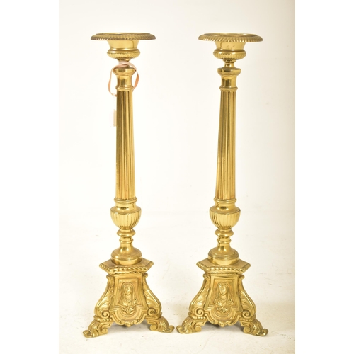 478 - A pair of 19th century Victorian brass floor standing prickets, likely ecclesiastical in nature. Eac... 