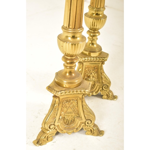 478 - A pair of 19th century Victorian brass floor standing prickets, likely ecclesiastical in nature. Eac... 