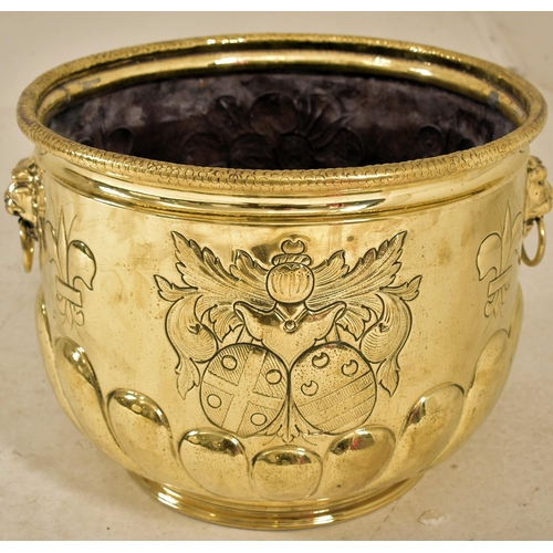 481 - A late Victorian gilded copper coal scuttle / log bin. The planted having embossed decoration throug... 