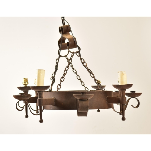 487 - A 20th century Medieval revival cast iron ceiling light / chandelier. The light having an oval bande... 