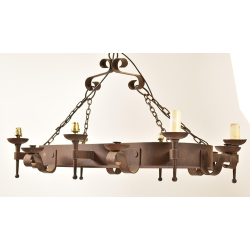 487 - A 20th century Medieval revival cast iron ceiling light / chandelier. The light having an oval bande... 