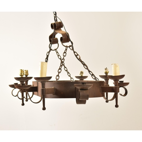 487 - A 20th century Medieval revival cast iron ceiling light / chandelier. The light having an oval bande... 