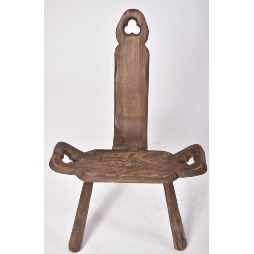 488 - A late 19th century Brutalist elm wood birthing milking tripod stool / chair. The stool having a han... 