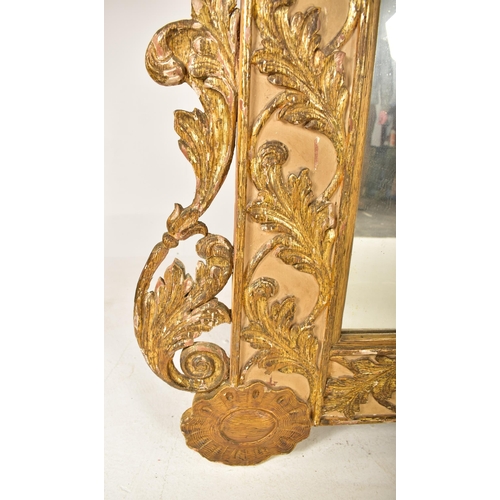 500 - A large continental 19th century Italian Rococo inspired gilt wood wall mirror. The mirror having an... 