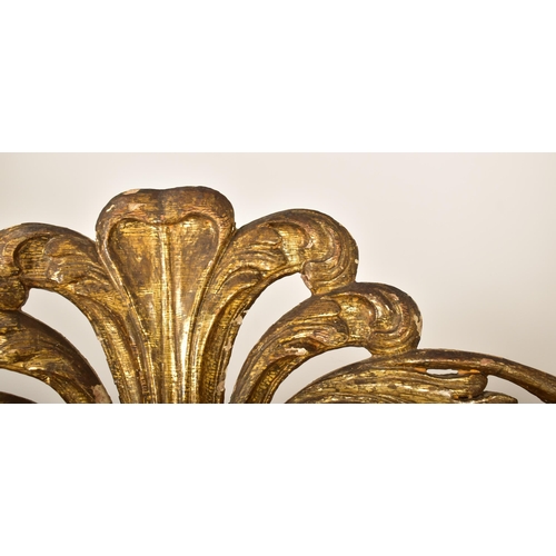 500 - A large continental 19th century Italian Rococo inspired gilt wood wall mirror. The mirror having an... 