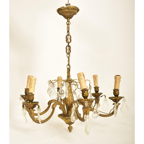 613 - A continental inspired early 20th century 1920s style gilded solid brass six arm ceiling chandelier.... 