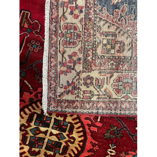 477 - A 20th century North West Persian Islamic Tafresh floor carpet rug. The rug having a central red, bl... 