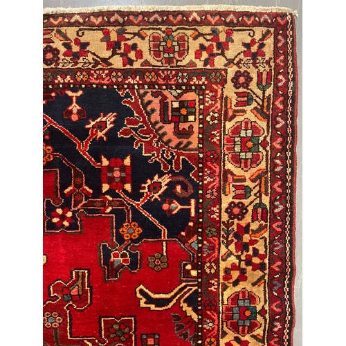 477 - A 20th century North West Persian Islamic Tafresh floor carpet rug. The rug having a central red, bl... 