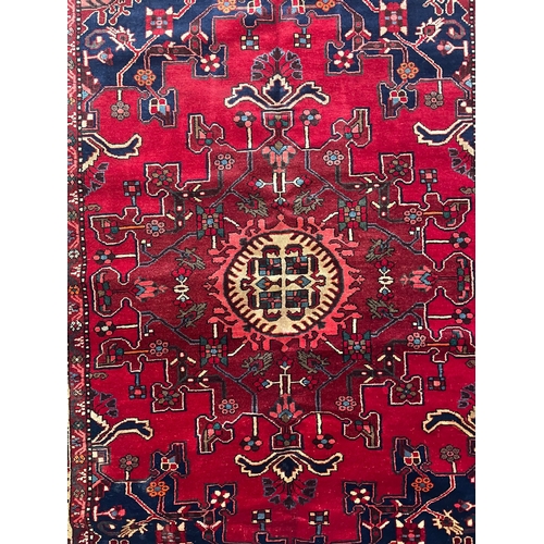 477 - A 20th century North West Persian Islamic Tafresh floor carpet rug. The rug having a central red, bl... 