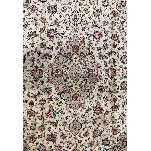 483 - An early 20th century Central Persian Islamic Kashan floor carpet rug. The rug having a cream ground... 