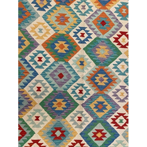 543 - A 20th century Anatolian Turkish Islamic Kilim floor carpet rug. The rug having a central cream pane... 