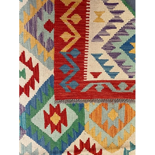 543 - A 20th century Anatolian Turkish Islamic Kilim floor carpet rug. The rug having a central cream pane... 