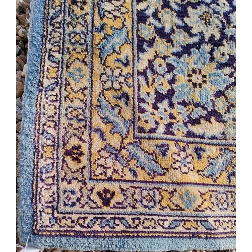 553 - A large 20th century Persian Islamic floor carpet rug. The rug on a light blue, cobalt & yellow grou... 