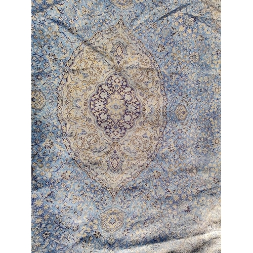 553 - A large 20th century Persian Islamic floor carpet rug. The rug on a light blue, cobalt & yellow grou... 