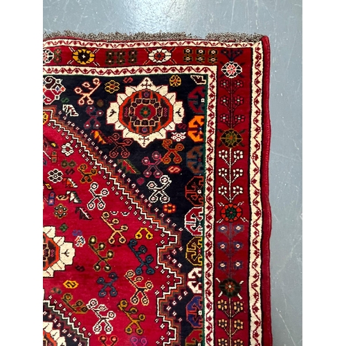 581 - A 20th century South West Persian Islamic Qashgai floor carpet rug. The rug having a central a centr... 