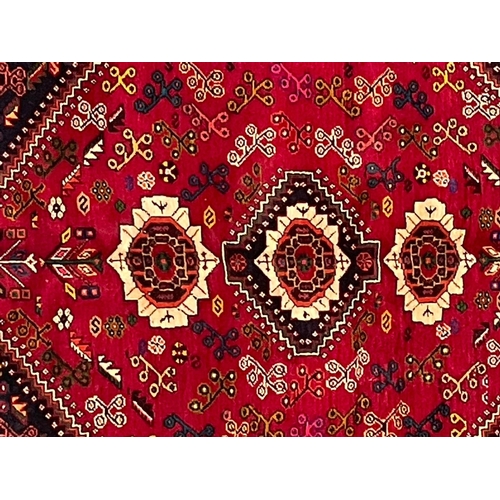 581 - A 20th century South West Persian Islamic Qashgai floor carpet rug. The rug having a central a centr... 