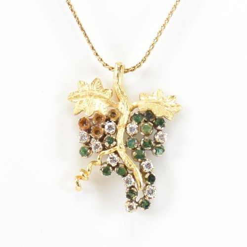 154 - An 18ct gold, emerald and diamond grapevine pendant necklace. The 18ct gold grapevine pendant set wi... 