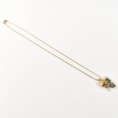 154 - An 18ct gold, emerald and diamond grapevine pendant necklace. The 18ct gold grapevine pendant set wi... 