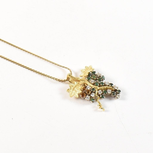 154 - An 18ct gold, emerald and diamond grapevine pendant necklace. The 18ct gold grapevine pendant set wi... 