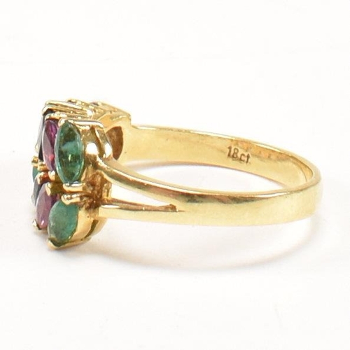 16 - An 18ct gold, emerald, sapphire and ruby cluster ring. The ring having twelve graduating marquis cut... 