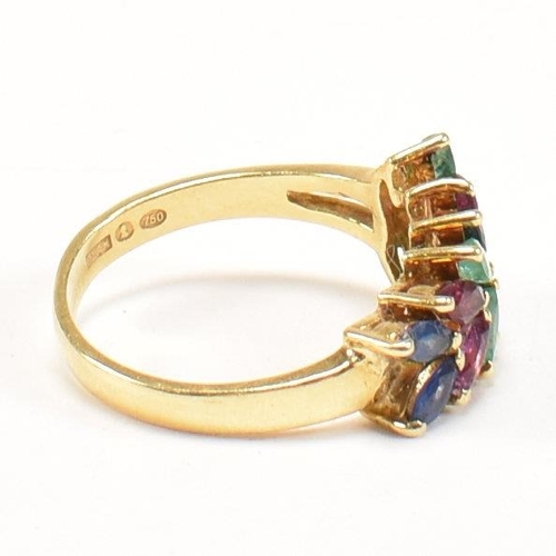 16 - An 18ct gold, emerald, sapphire and ruby cluster ring. The ring having twelve graduating marquis cut... 