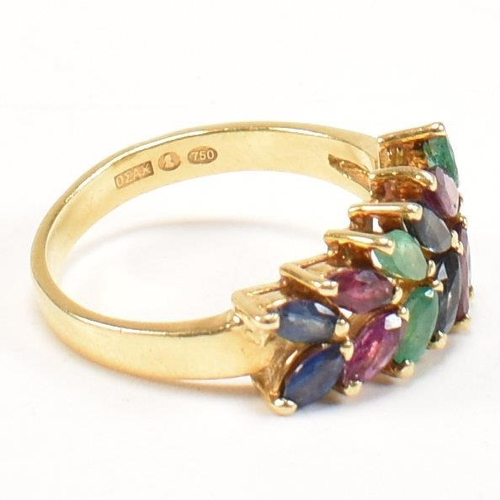 16 - An 18ct gold, emerald, sapphire and ruby cluster ring. The ring having twelve graduating marquis cut... 