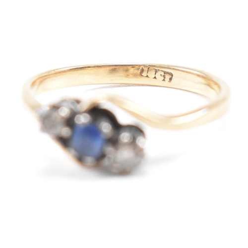 181 - An 18ct yellow gold, sapphire and diamond three stone crossover ring. The ring having a central oval... 