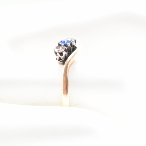 181 - An 18ct yellow gold, sapphire and diamond three stone crossover ring. The ring having a central oval... 