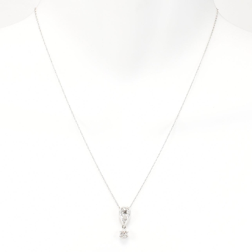 21 - A 14ct white gold and diamond pendant necklace. The necklace strung with a diamond drop pendant. The... 